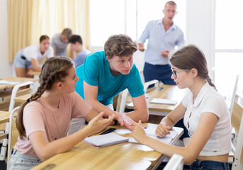 Fototapeta premium Fellow students having group work tasks during school day