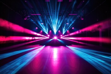 Vibrant pink and blue stage lighting illuminates an empty concert venue, creating a dramatic atmosphere.