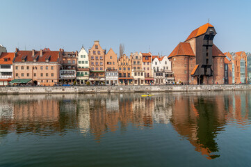 Gdansk old city in Poland with the oldest medieval port crane (Zuraw) in Europe,  St John church, Motlawa River and old  granaries.