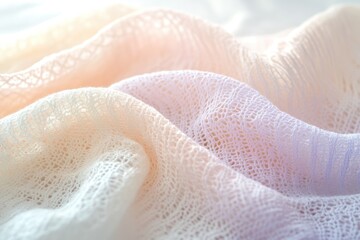 Obraz premium Soft, pastel-colored knitted fabric with delicate lace pattern, draped beautifully.