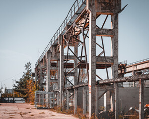 Old rusty factory building and equipment. Heavy industry steel mill technology mechanisms and tools. Rusty construction equipment on working factory. 