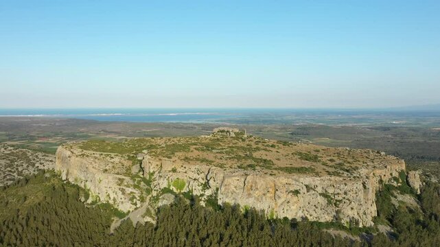 The castle of Opoul Perillos overlooking the valleys from its promontory in Europe, in France, in Occitanie, in the Pyrenees Orientales, in summer, on a sunny day.&nbsp;