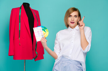 woman in white shirt holds color palette next to red blazer on mannequin, expressing bright idea...
