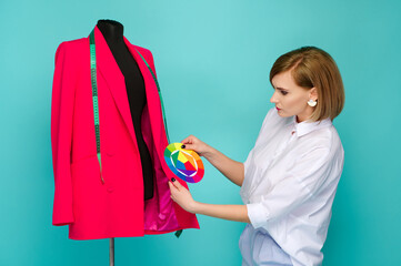fashion designer inspects mannequin with pink blazer, holding color wheel against blue background....