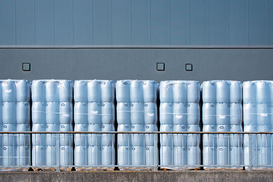 new and clean round plastic barrels or wide neck drum with lid and clamping ring. Plastic drums, round plastic bins stacked on the pallet