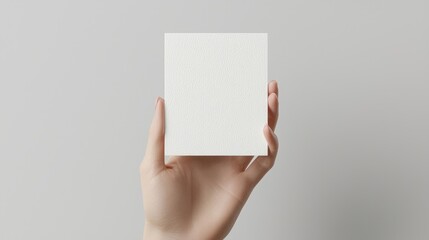 Obraz premium Blank square note held in hand