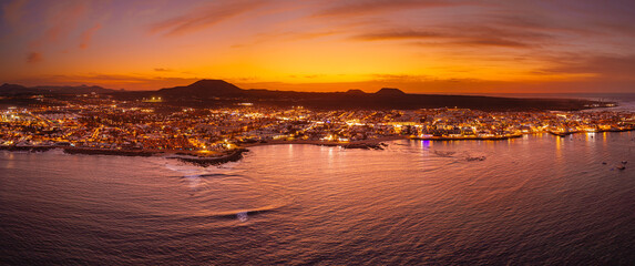 Spectacular aerial panoramic landscape image of the evening sunset sky at golden hour over the town of Corralejo, Fuerteventura, Canary Islands, Spain