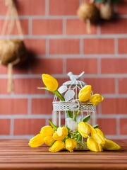 Decorative birdcage, flowers in a cage, yellow tulips in a decorative cage