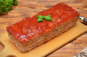 classic American meatloaf on a cutting board on the table closeup