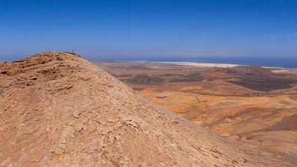 Dramatic aerial image of Montana Escanfraga and the volcanic mountain landscape and coastline near Villaverde in Fuerteventura Canary Islands Spain	