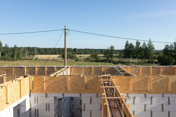 Construction Site Overview: Wide View of Concrete Foundation with Rebar and Formwork Under Clear Blue Sk