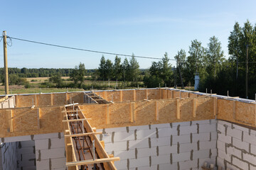Construction of Aerated Concrete House with Reinforced Beam Formwork and Scenic Forest Background in Summer