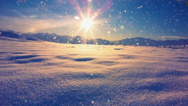 Picure of snow-covered ground at sunset in high altitude mountainous area.