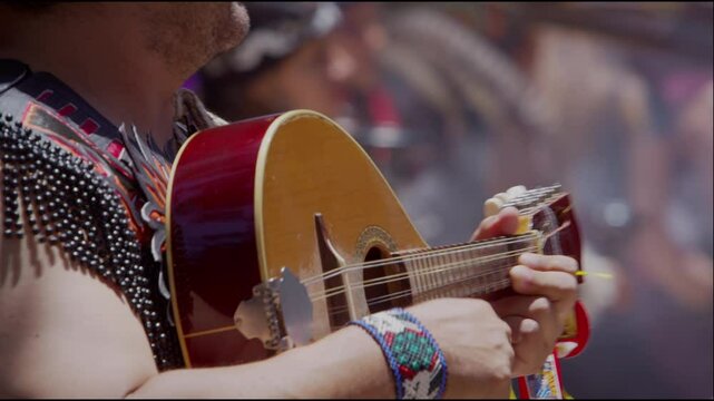 Musician Playing Traditional String Instrument in Cultural Celebration 