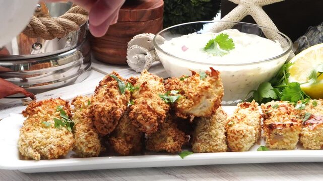 Using an air fryer to make homemade fish sticks for a quick and easy dinner,  Breaded fish sticks being cooked in an air fryer.  Easy seafood dinner meal.