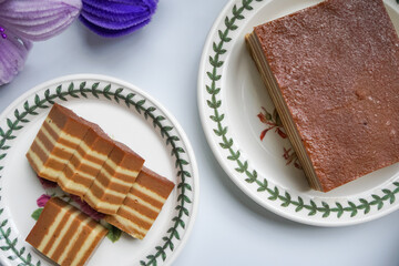 A traditional Indonesian steamed layer cake with alternating vibrant layers, showcasing a soft, moist texture and rich flavors, perfect for festive occasions.