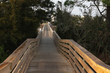 Obraz premium Scenic Walk Crossover. A scenic wooden footbridge at the end of 9th Street over the Davis Canal, Oak Island, North Carolina.