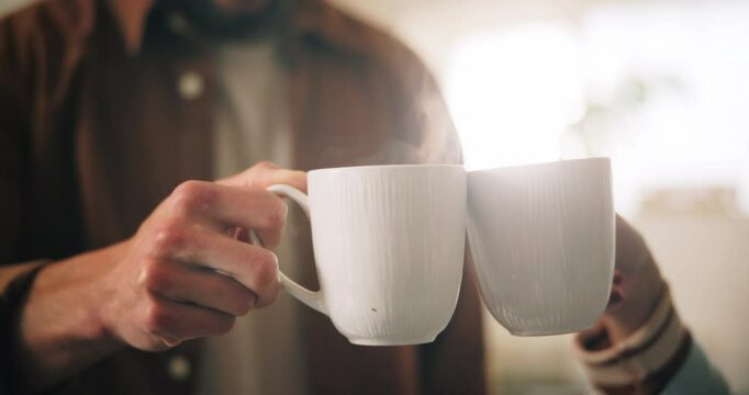Cheers, coffee and couple with mugs in home in morning for bonding, love and connection together. Relax, commitment and man with woman drinking cappuccino, latte or espresso for toast to marriage.