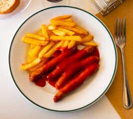 Sweet and sour tomato sauce successfully complements taste of grilled sausages and French friessausages