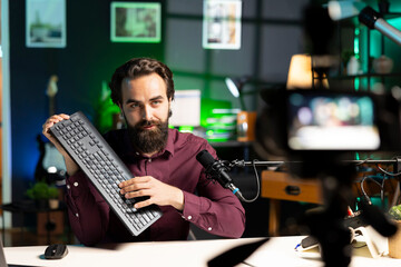 Content creator filming keyboard review in personal studio, pressing different buttons to show...
