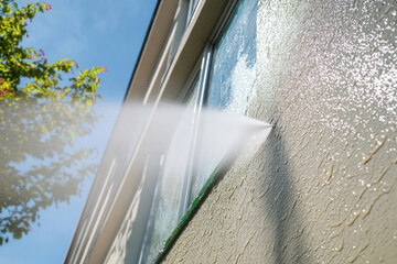 service for washing building facades and windows with high pressure water. power washing a wall. cleaning the facade of a house. before and after pictures.