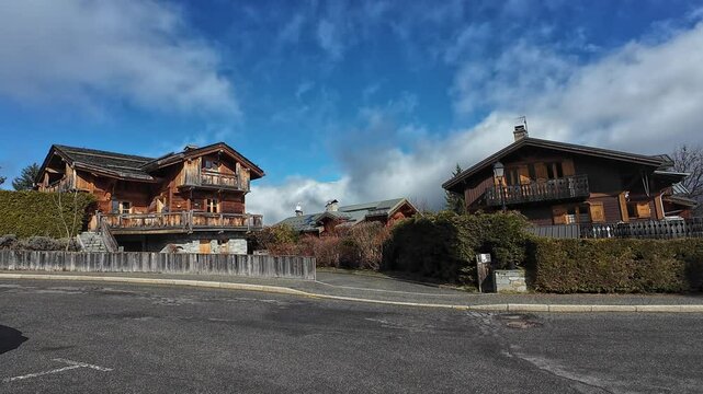 Charming street of Le Praz, Courchevel, France, lined with traditional wooden chalets