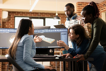 Male and female creative professionals brainstorming ideas to enhance a 3D scene on computer. Multiethnic digital artists working together to optimize mesh details using specialized CAD software.
