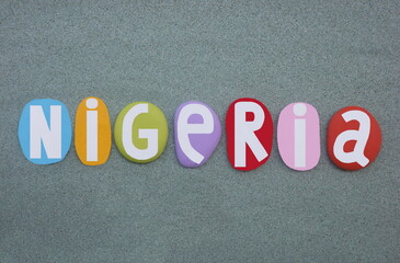 Nigeria, officially the Federal Republic of Nigeria, country in West Africa, creative logo composed with multi colored painted stone letters over green sand