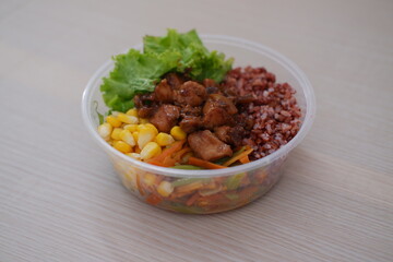 a nutritious meal served in a transparent plastic bowl, ideal for takeaway
