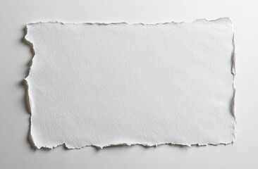 A blank. torn-edge sheet of textured white paper lying flat on a neutral background. ideal for creative projects. invitations. or artistic displays