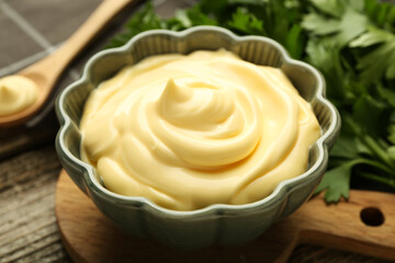 Delicious mayonnaise sauce in bowl on table, closeup