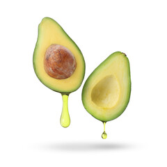 Halves of avocado with dripping oil in air on white background
