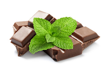 Milk chocolate pieces and mint leaves on white background