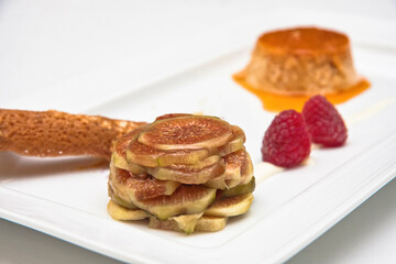 Flan with figs and raspberries, fig and raspberry dessert with caramel on a white background