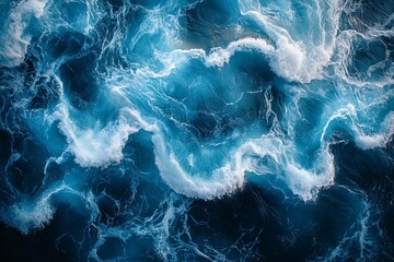 A beautiful aerial view of swirling ocean waves and white foam