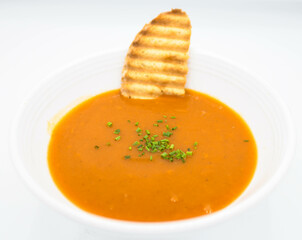 pumpkin soup with croutons on a white background in the restaurant