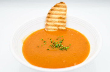 pumpkin soup with croutons on a white background in the restaurant
