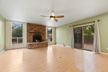 Spacious living room with wooden flooring and sliding doors leading to a bright outdoor area