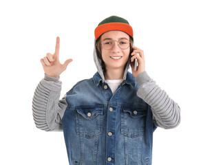 Cool teenage boy talking by mobile phone on white background