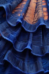 Close-up of vibrant ultramarine ruffled fan fabric, showcasing captivating curves, rich textures,...