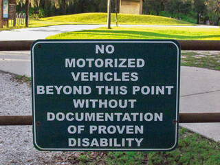No Motorized Vehicle Beyond This Point Without Documentation of Proven Disability Sign