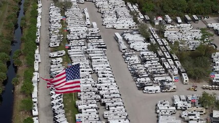 New camping trailers parked for sale on RV dealer parking lot in Ft. Myers, Florida.