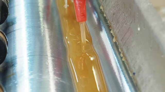 Efficient glue application technique on rollers for optimal adhesion in manufacturing processes