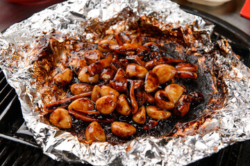 Spicy marinated squid and garlic on foil
