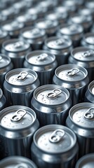 Endless rows of shiny aluminum cans forming a repetitive pattern, perfect visual for manufacturing, beverage industry, mass production and commercial packaging themes


