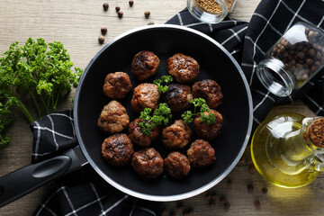 Meatballs in a pan on a wooden background
