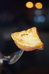 Delicious slice of dessert served on a fork at an evening gathering