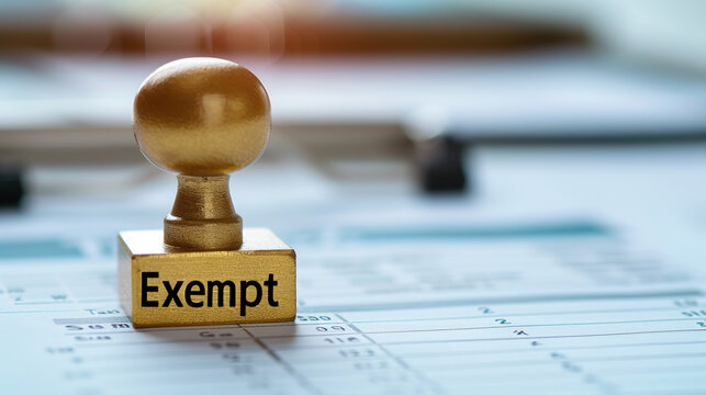 Golden tax exempt stamp pressed on official document with copy space, financial approval concept, government tax relief policy and legal exemption certification for business.