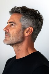 Obraz premium A sophisticated male posing with grace. Pure white solid background. Concept art idea of style for aging men. Modish men's crew cut haircut - midlife white man with grey hair.