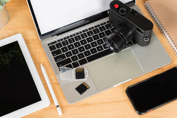 Top view. Flat lay. Laptop, external hard drive, modern digital camera. Two sd memory cards.
